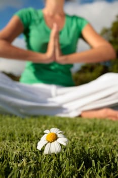 Woman Meditating with Blue Sky and Daisies