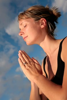 Woman Meditating with Blue Sky
