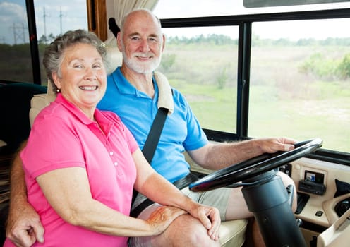 Portrait of active senior couple in their motor home.