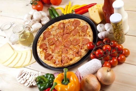 A couple of delicious pizzas, with raw tomatoes, green peppers and salami