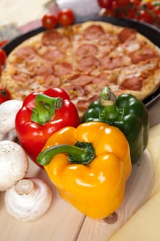 A couple of delicious pizzas, with raw tomatoes, green peppers and salami