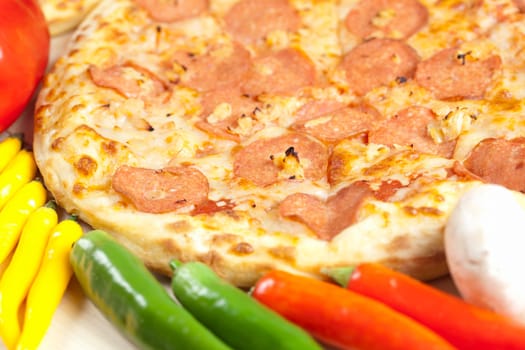 A couple of delicious pizzas, with raw tomatoes, green peppers and salami