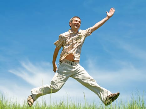 a happy man is running through the meadow
