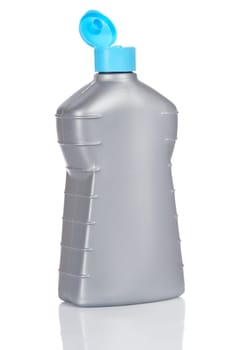 Opened plastic detergent bottle reflected on white background
