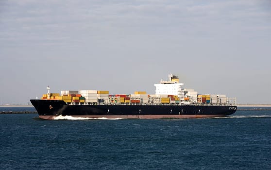 Container ship is leaving the Port of Rotterdam