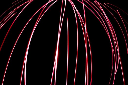 An abstract light background showing motion blurred light on a dark background.
