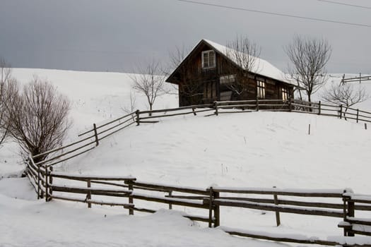 Cottage on the hill with lots of snow.