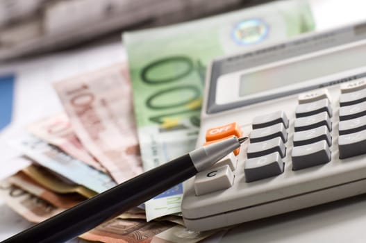 news papers with dollars and a pocket calculator