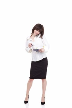 The beautiful girl speaks by phone and is going to write to a notebook