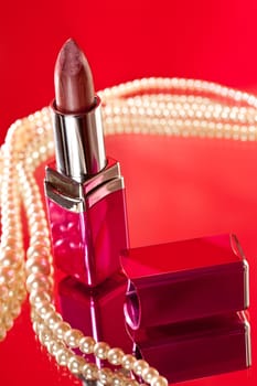 make up object: lipstick over red background