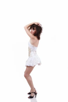 The young beautiful girl dancing in a short white dress
