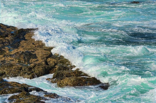 great image of strong waves splashing into the rocks