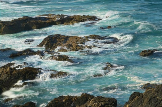 great image of strong waves splashing into the rocks