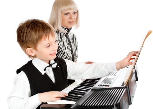 Mother and her preschool son playing electric piano