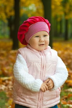 Thoughtful toddler in the autumnal city park