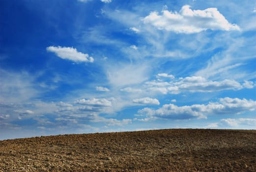 Stunning cloudy background over plowed land