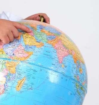 Kid studying the globe.