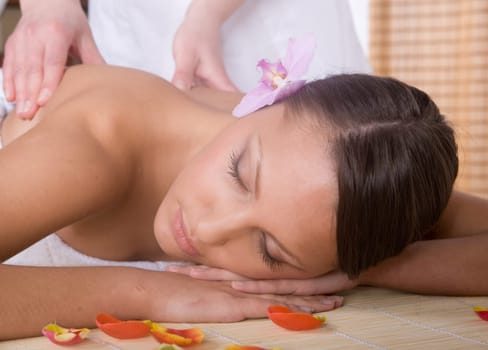 young woman relaxing in spa salon