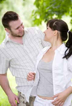 happy couple together sitting on grass