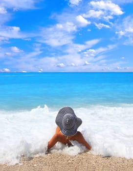 Beautiful young woman enjoying the Ionian sea in Greece