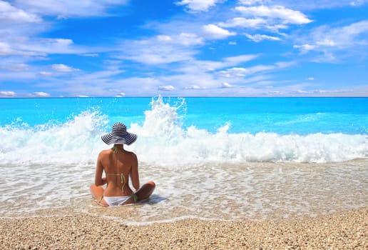 Beautiful young woman enjoying the Ionian sea in Greece