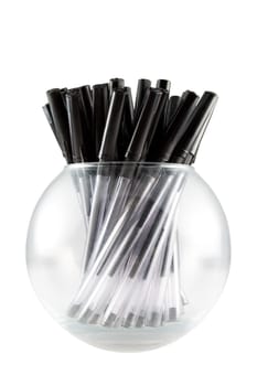 a clear glass ball full of black pens