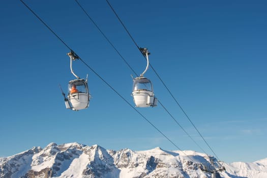 Ski lift cabins against clear blue sky