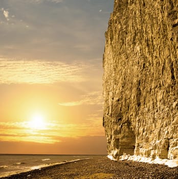 Sun setting at the coast whit large chalk cliff
