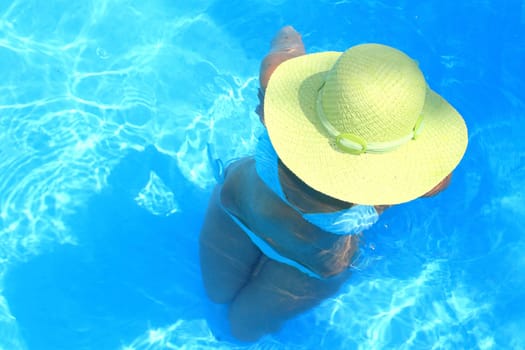 Pretty woman enjoying a swimming pool in Greece