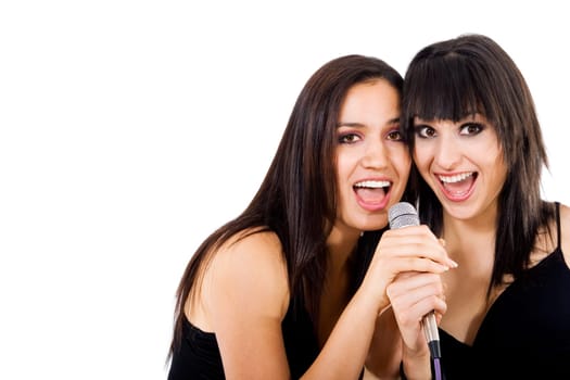Stock photo of two girls singing, isolated on white with copy space