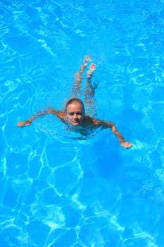 Pretty woman enjoying a swimming pool in Greece