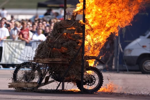 Stunt rider riding through a wall of flames