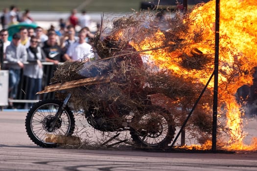 Stunt rider riding through a wall of flames