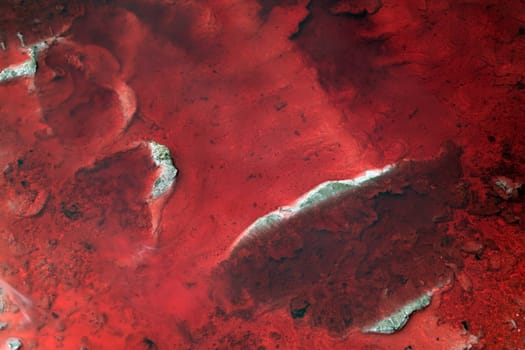 Abstract of a red diesal pollution spill.
