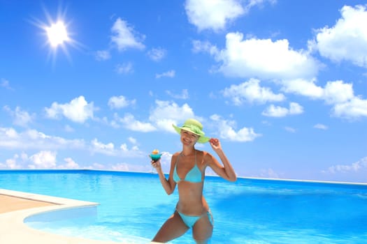 Pretty woman enjoying a swimming pool in Greece