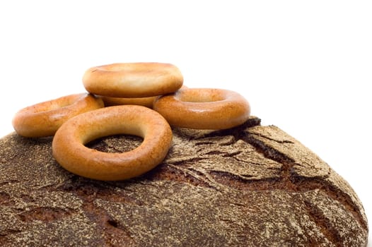 Loaf of bread and bread ring on white background