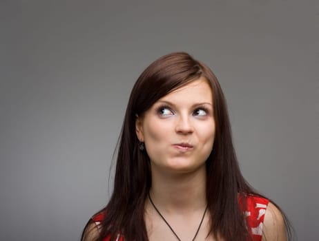 Closeup portrait of a thinking young woman