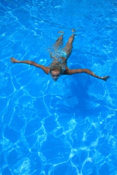 Pretty woman enjoying a swimming pool in Greece