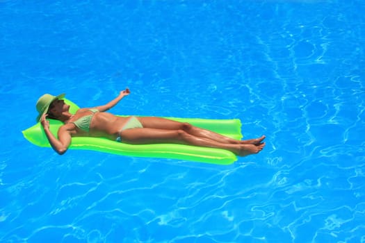 Pretty woman enjoying a swimming pool in Greece