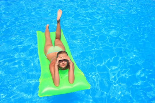 Pretty woman enjoying a swimming pool in Greece