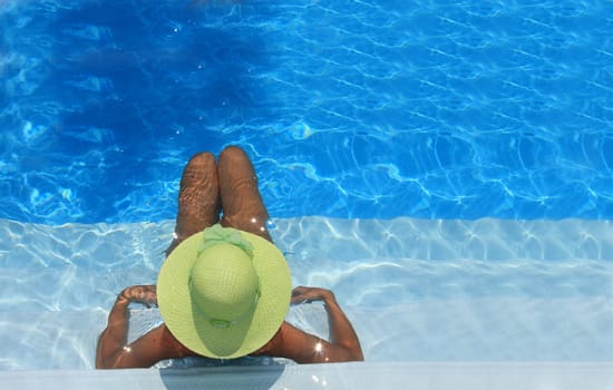 Pretty woman enjoying a swimming pool in Greece