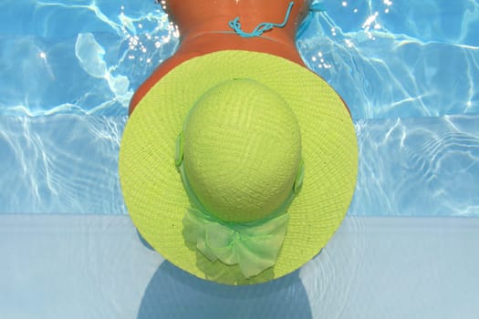Pretty woman enjoying a swimming pool in Greece