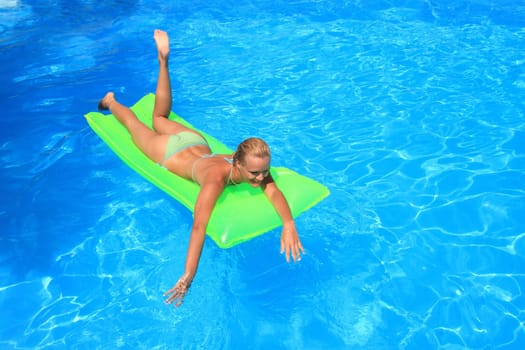 Pretty woman enjoying a swimming pool in Greece