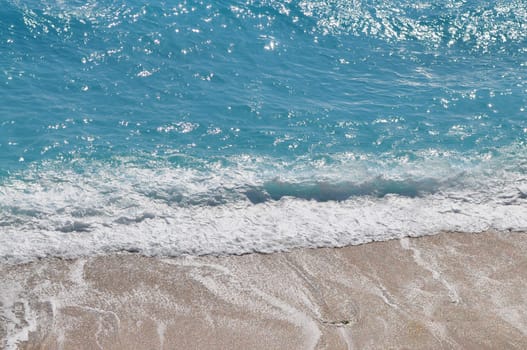 Beach wave and blue sea foam