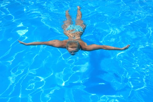 Pretty blonde woman enjoying a swimming pool in Greece