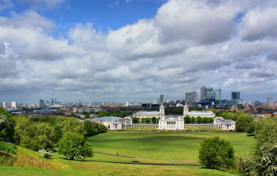 The view on Greenwich and London from the Royal Observatory in a sunny day but with many clouds on the blue sky