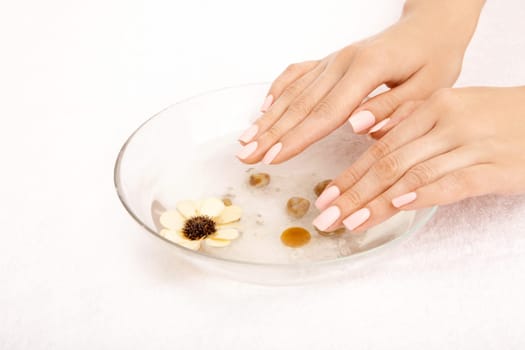 Female hands in the salt tray, isolated