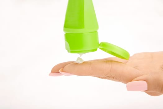 Female hand and cream from a tube, isolated