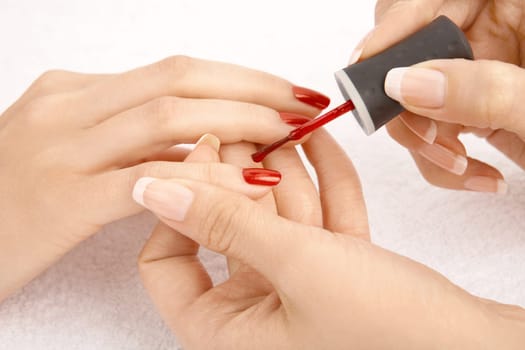 Close up - drawing of a red varnish on the nails, isolated