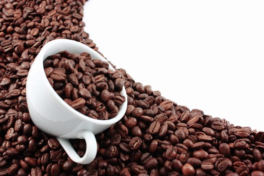 White cup filled with coffee beans
